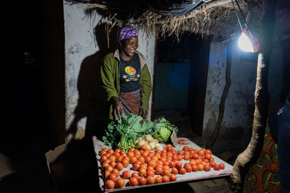 A Trader Uses Her Light To Sell Her Produce At The Local Market. Photo Credit Solaraid Jason J Mulikita