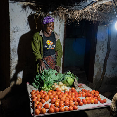 A Trader Uses Her Light To Sell Her Produce At The Local Market. Photo Credit Solaraid Jason J Mulikita